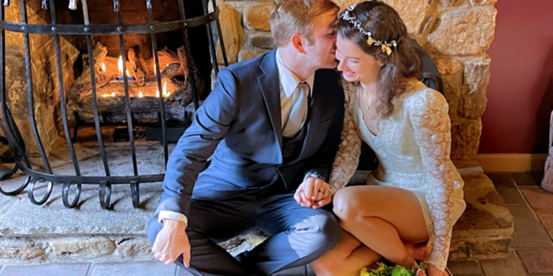 Couple in front of fireplace